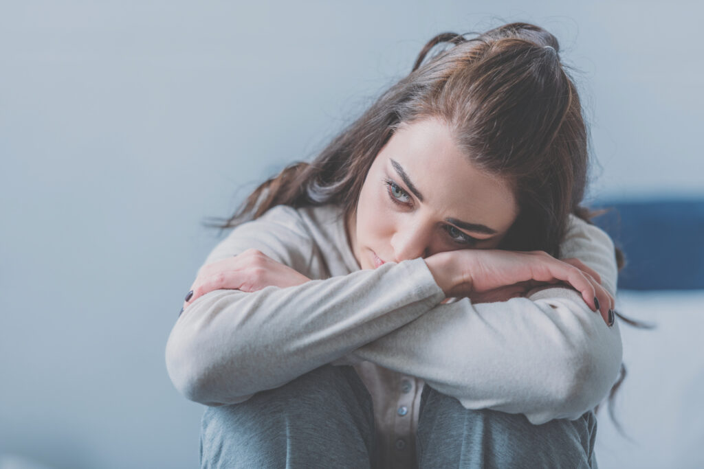 young woman feeling overwhelmed with guilt and shame