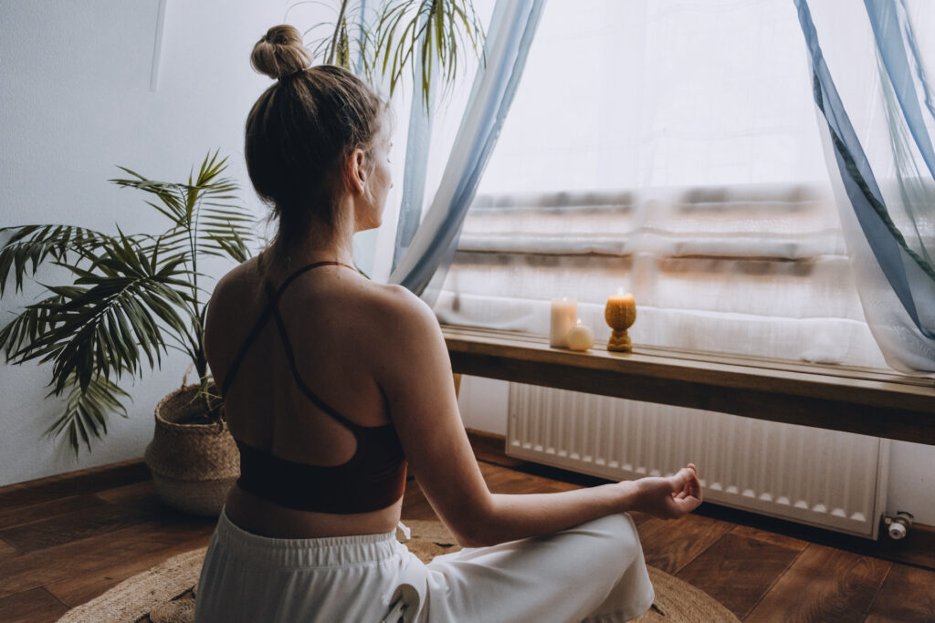 woman meditating and regaining energy and positive feelings