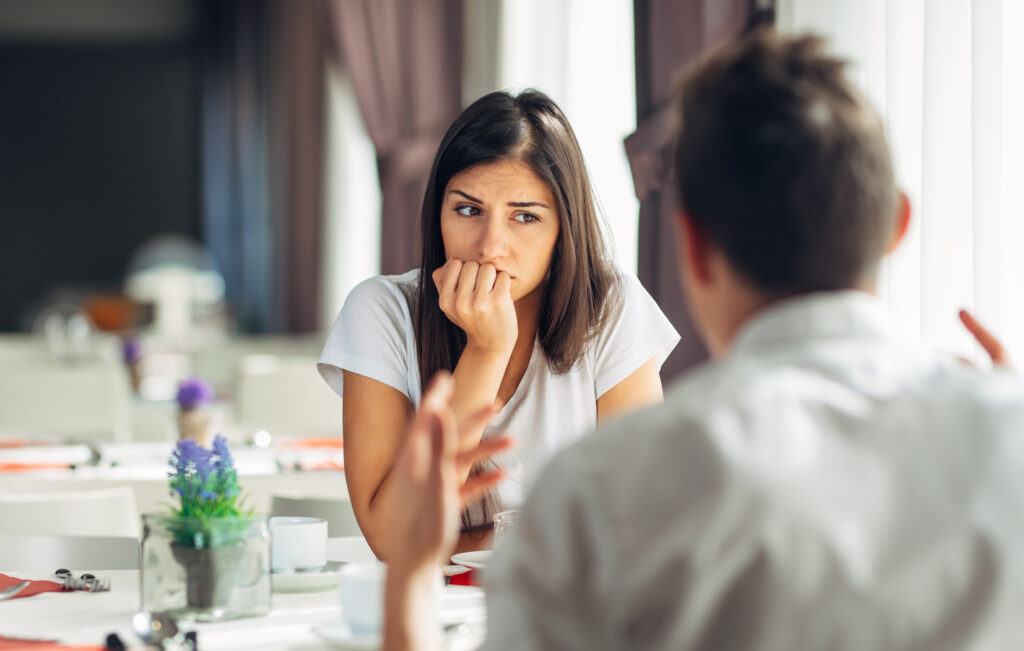 Woman looking worried speaking to partner about addiction