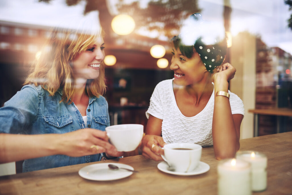 Two women having a conversation in a cafe around trust