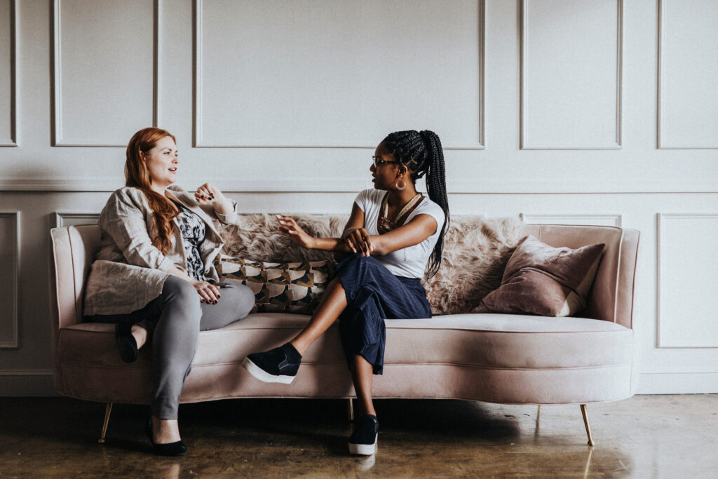 two friends discussing stigma on a couch