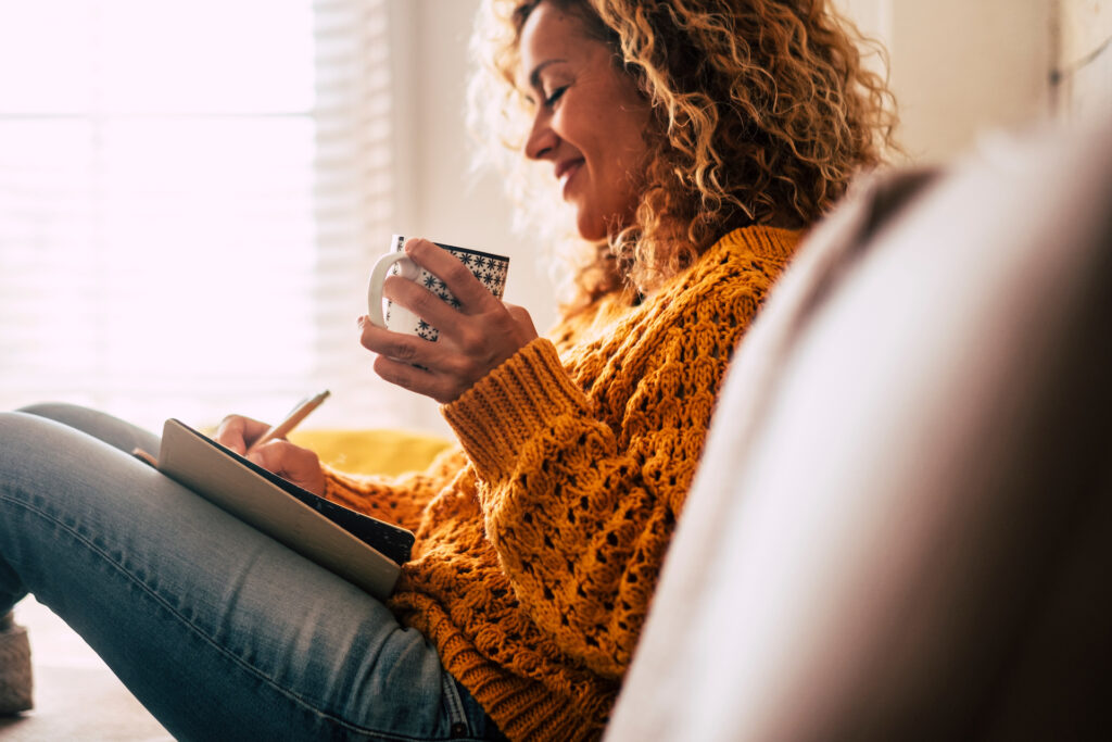 woman writing in journal good state of mental health