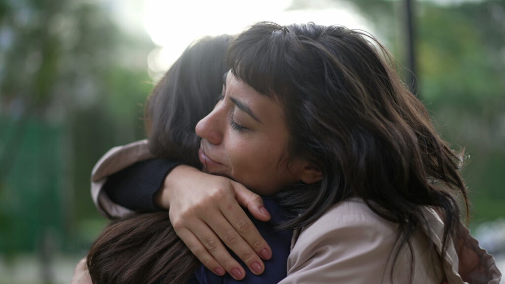 two friends embracing and healing together