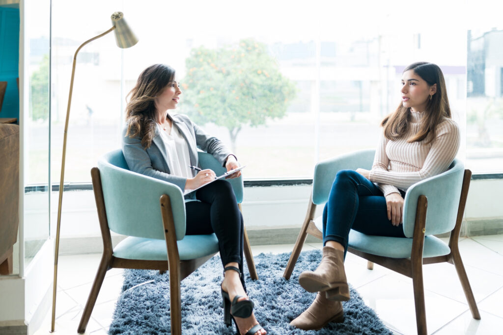 woman meeting with therapist discussing body image