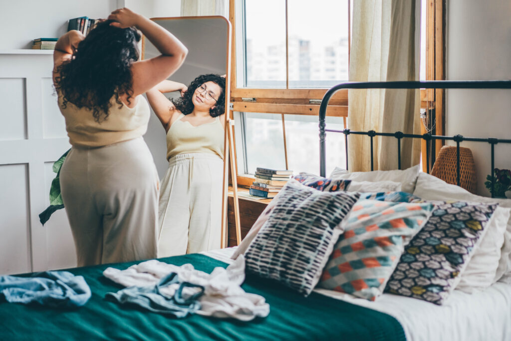 woman looking in mirror befriend yourself