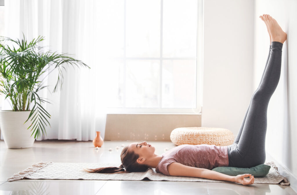 woman laying on back stretching