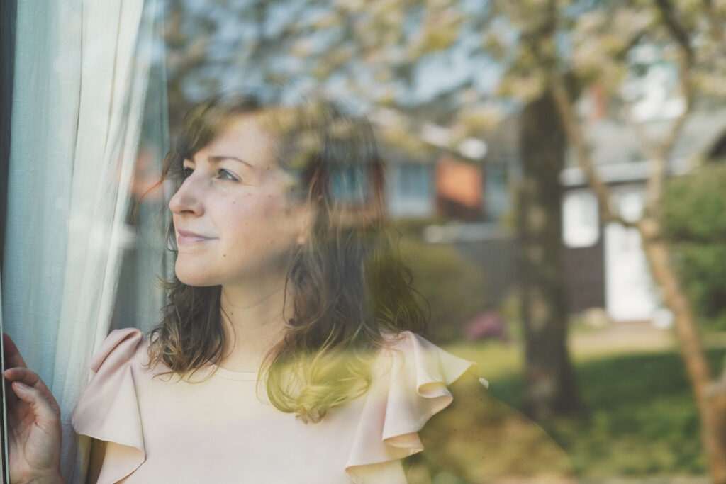 woman looking outside thinking about change