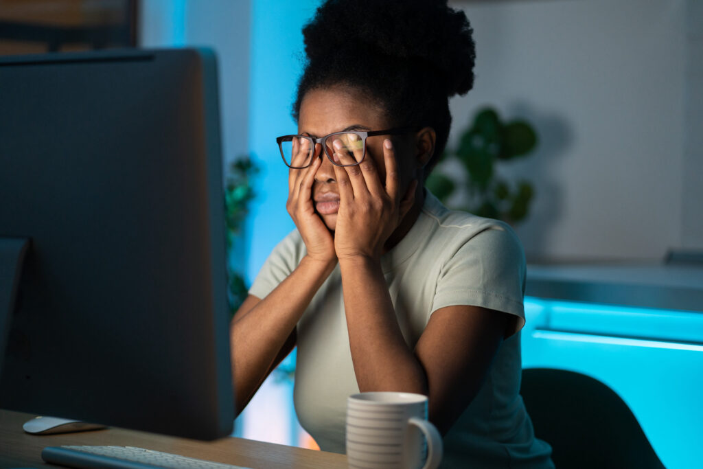 woman on computer putting off sleep