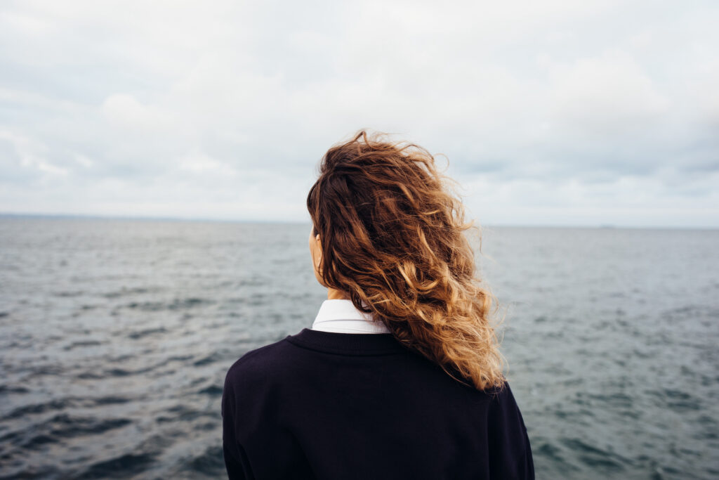 woman looking out at ocean